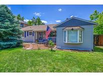 Charming home with a well-maintained lawn and garden, complete with an American flag at 3313 S Dexter St, Denver, CO 80222