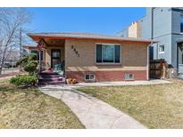 Charming brick home featuring a cozy front porch and well-maintained landscaping at 2301 Vine St, Denver, CO 80205