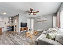 Inviting living room featuring a ceiling fan and a comfortable gray couch at 1135 S Oneida St # F, Denver, CO 80224