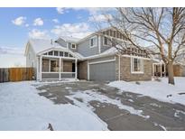 Two-story house with gray siding, stone accents, and a covered porch at 5928 E Conservation Dr, Frederick, CO 80504