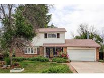 Charming two-story home with a brick and white facade and well-maintained landscaping at 9290 Quitman St, Westminster, CO 80031