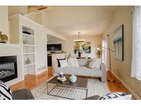 Inviting living room featuring a fireplace, modern decor, and an open floor plan at 15555 E 40Th Ave # 30, Denver, CO 80239