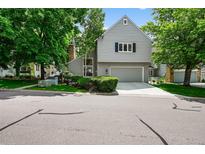 Charming two-story home with a gray exterior, well-manicured landscaping, and an attached two-car garage at 4505 S Yosemite St # 125, Denver, CO 80237