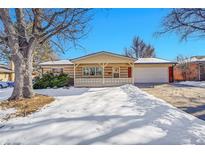 Ranch style home with attached garage and snowy front yard at 130 S Eaton St, Lakewood, CO 80226