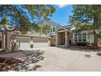 Charming two-story home with a three-car garage and well-manicured landscaping at 2187 Wynterbrook Dr, Highlands Ranch, CO 80126