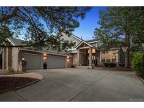 Charming home featuring a three-car garage, brick facade, and well-manicured landscaping at 2187 Wynterbrook Dr, Highlands Ranch, CO 80126