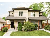 Charming home exterior with inviting front porch, tidy lawn, and modern architectural details at 2435 S High St, Denver, CO 80210