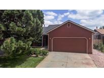 Charming home featuring a two-car garage and mature landscaping at 4396 Dearborn St, Denver, CO 80239