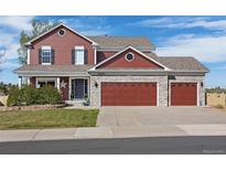 Charming two-story home featuring a three-car garage and well-maintained landscaping at 20670 Bridlewood Ln, Parker, CO 80138