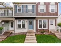 Charming townhome with steps leading to a welcoming front door and colorful exterior at 9632 W Cornell Pl, Lakewood, CO 80227