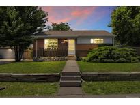 Charming brick home featuring a well-manicured lawn and inviting front porch at 1760 W 74Th Way, Denver, CO 80221