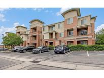 Modern condominium building with brick accents, balconies and ample parking on a sunny day at 4100 Albion St # 617, Denver, CO 80216