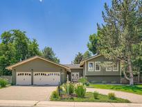 Charming home featuring a lush front yard and a convenient two-car garage at 5254 W Oberlin Dr, Denver, CO 80235