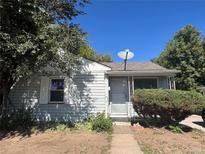 Charming single-story home featuring a cozy front porch and mature trees, offering great curb appeal at 3345 W Evans Ave, Denver, CO 80219