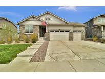 Charming single-Gathering home featuring stone accents, three-car garage, and well-manicured lawn at 8248 S Yantley Ct, Aurora, CO 80016