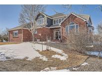 Brick two-story home with a large front yard and attached garage at 7119 S Riviera St, Aurora, CO 80016