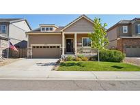 Charming single-Gathering home with a well-manicured lawn, a covered porch, and an attached two-car garage at 5425 E 125Th Pl, Thornton, CO 80241