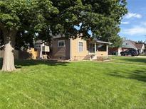 Charming single-Gathering home featuring a covered front porch and a well-maintained lawn at 458 Cherry St, Hudson, CO 80642
