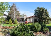 Charming single-story home with a landscaped front yard and a cozy front deck at 6625 E 6Th Avenue Pkwy, Denver, CO 80220