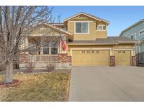 Charming two-story home featuring a cozy front porch and a spacious three-car garage at 3570 S Malaya St, Aurora, CO 80013