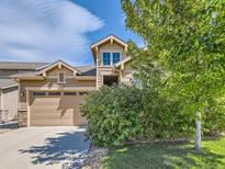 Inviting two-story home with a neatly trimmed lawn and a two car garage under a partly cloudy sky at 16658 Prospect Ln, Broomfield, CO 80023