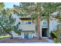 Exterior of a multi-story residential building with well-maintained landscaping and visible unit entrances at 10150 E Virginia Ave # 7-204, Denver, CO 80247