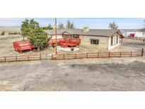 Ranch-style home featuring a spacious deck and a fenced yard, perfect for outdoor living at 1632 S County Road 137, Bennett, CO 80102