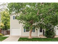 Charming two-story home with a well-manicured lawn, an attached garage, and lovely curb appeal at 4619 S Tabor Way, Morrison, CO 80465