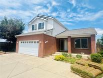 Charming two-story home with brick accents, a two-car garage, and newly installed grass at 19033 E 22Nd Cir, Aurora, CO 80011