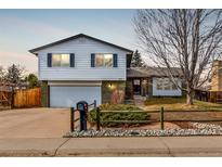 Charming split-level home with well-maintained lawn and inviting curb appeal at 3411 S Olathe Way, Aurora, CO 80013