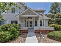 Charming home featuring a covered front entrance with a walkway and manicured landscaping at 4013 S Carson St # C, Aurora, CO 80014