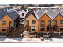 New construction showing modern townhomes in light brown with black trim at 5780 W 92 Ave, Westminster, CO 80031