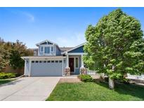 Charming two-story home featuring a well-manicured lawn and a two-car garage at 4821 Bluegate Dr, Highlands Ranch, CO 80130