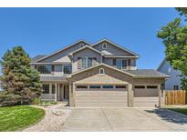 Beautiful two-story home with a three-car garage, manicured lawn and mature landscaping at 11803 E 114Th Pl, Commerce City, CO 80640