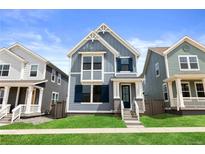 Charming blue two-story home with landscaped front yard and inviting entrance at 223 Washington St, Erie, CO 80516