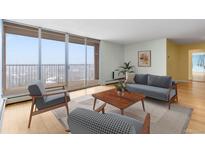 Bright living room with large windows, balcony access, and stylish furnishings. Ready to relax and enjoy the view! at 955 Eudora St # 1106, Denver, CO 80220