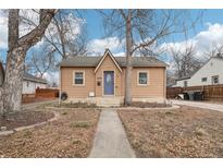 Charming single-story home with a blue door and well-maintained front yard at 1038 9Th Ave, Longmont, CO 80501