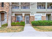 Inviting townhome exterior with well-maintained landscaping, stone accents, and a charming front porch at 12711 Colorado Blvd # B-218, Thornton, CO 80241