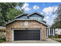 Charming two-story home featuring a stone facade and a well-manicured front yard at 5265 S Cathay Way, Centennial, CO 80015