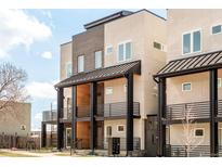 Modern townhome exterior with striking architecture, private balconies, and contemporary design elements at 2105 S Galapago St # 4, Denver, CO 80223