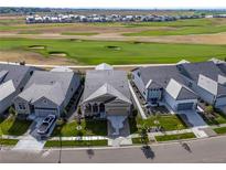 Stunning aerial view of homes overlooking the golf course and scenic surroundings at 3214 Heron Lakes Pkwy, Berthoud, CO 80513