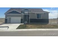 Charming home with modern garage door and gray accents, situated on a bright lot at 42978 Colonial Trl, Elizabeth, CO 80107