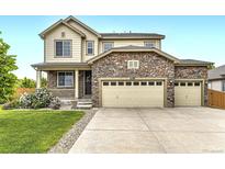 Charming two-story home featuring a stone facade and a spacious three-car garage at 6108 S Harvest Ct, Aurora, CO 80016
