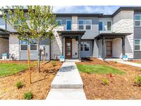 New two-story townhomes with stone accents, modern design, and professionally landscaped front yards at 5783 N Jericho Way, Aurora, CO 80019