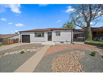 Charming single-story home features a well-maintained exterior with a landscaped front yard and an attached garage at 716 S Osage St, Denver, CO 80223