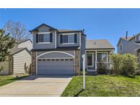 Charming two-story home with a well-manicured lawn, attached garage, and inviting front porch at 3734 Licorice Trl, Castle Rock, CO 80109