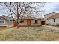 Brick ranch home with landscaped yard and attached carport at 4324 Eaton St, Denver, CO 80212