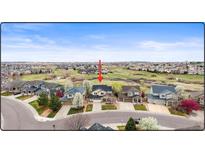 Charming neighborhood view showcasing lush green spaces and well-maintained homes under a blue sky at 5049 Heatherglen Dr, Highlands Ranch, CO 80130