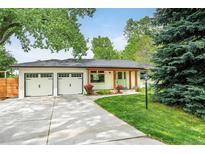 Charming single-story home with a well-manicured lawn, two-car garage, and appealing curb appeal at 6891 W Eldorado Pl, Lakewood, CO 80227
