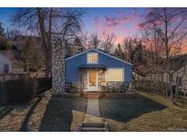 Charming blue house with a stone chimney and welcoming front porch at 709 2Nd St, Golden, CO 80403
